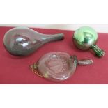 An early 19th C free blown green glass baby feeder (L19cm), a green glass mallet shaped bottle and a