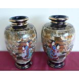Pair of Japanese Satsuma vases, ovoid bodies decorated with figures in landscapes, within panels