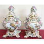 Pair of Dresden porcelain vases and covers, the flower encrusted bodies painted with castles and