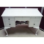 Painted kneehole dressing table with central drawer flanked by four short drawers, on pad feet (W