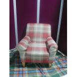 Modern upholstered armchair on lightwood tapering supports, upholstered in checked fabric