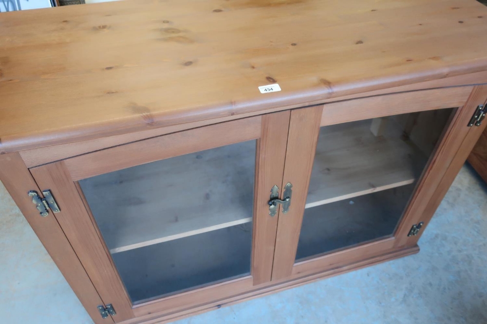 Modern pine side cabinet enclosed by pair of glazed doors (118cm x 48cm x 82cm)