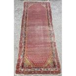 20th C Indo-Persian runner, red ground with geometric pattern border (300cm x 116cm)