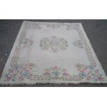 20th C Indian wool rug, cream ground with central floral medallion and patterned floral border (