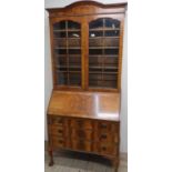 Queen Anne style walnut bureau bookcase with arched top and three shelves, above fall front and