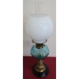 Early 20th C paraffin lamp, turquoise resevoir and opaque shade, on embossed brass pedestal base (