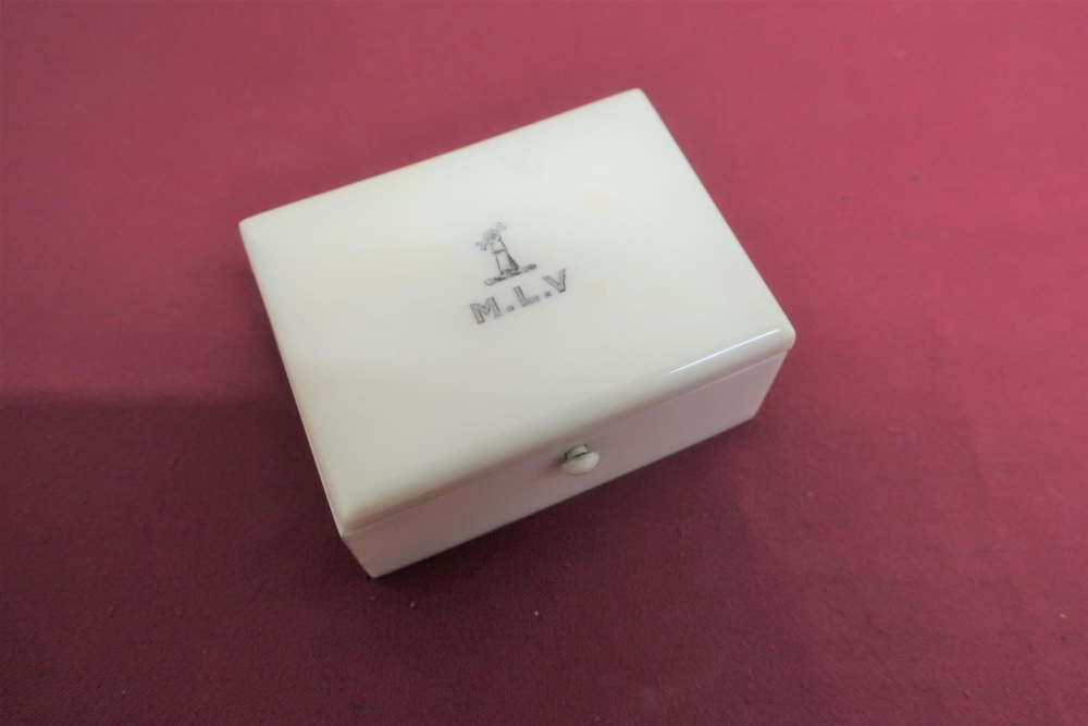 Early 20th C ivory rectangular box, sprung clip hinged lid with armorial of an arm holding a bone