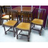 1950's oak draw leaf dining table, and a set of four chairs with drop in seats and turned supports