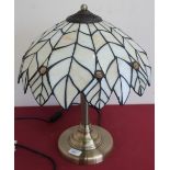 Table lamp with Tiffany style glass shade on brushed metal column support an circular base (45cm
