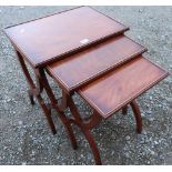 Nest of three Regency style mahogany rectangular tables on X shaped supports, joined by