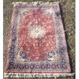 20th C Persian pattern rug, rust ground with geometric stylized central medallion and floral pattern