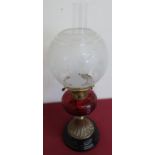 Late Victorian oil lamp with etched shade and red glass reservoir, on brass and slag glass