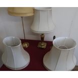 Three brass table lamps and five matching shades