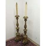 Pair of 17th C style gilt wood torchere style standard lamps with carved and moulded decoration. (