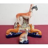 Large Victorian Staffordshire model of a greyhound with a fallen hare, on a natural base (H29cm);