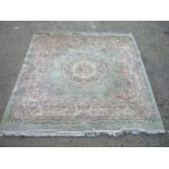 20th C chinese embossed woolen washed rug, green ground floral central patterned medallion, rose