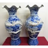 Pair of large Japanese blue & white vases, the baluster bodies relief decorated with an entwined