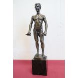 A bronze figure of a naked man wearing roman style laurel to the head with remains of sword in his