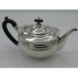 Geo. V hallmarked silver small teapot of ribbed oval form with ebonised finial and handle, London