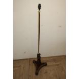 Regency rosewood pole screen, the brass column on scroll carved trefoil base with brass moulding and
