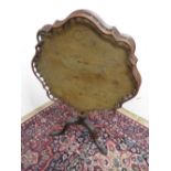 George II style mahogany tripod table, moulded shaped circular galleried tilt top on vase turned