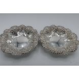 Pair of Edwardian hallmarked silver circular sweetmeat dishes, pierced and repousse with foliage,