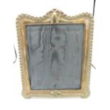 A modern silver hallmarked rectangular easel picture frame with gadrooned border and serpentine top,