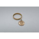 22ct gold hallmarked wedding band, 3.6g and a 9ct gold hallmarked St. Christopher charm, 4.6g