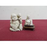 19th/20th C carved ivory Netsuke of a figure with child (H4.5cm), and another similar small Buddha