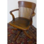 20th C oak office chair, with curved top rail, slat back and brass nailed rexine seat on four shaped