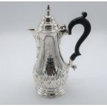 Geo. lll hallmarked silver coffee pot, baluster body relief decorated with leafage and crest,