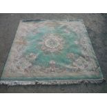 20th C chinese embossed woolen rug, green ground central floral medallion and floral pattern