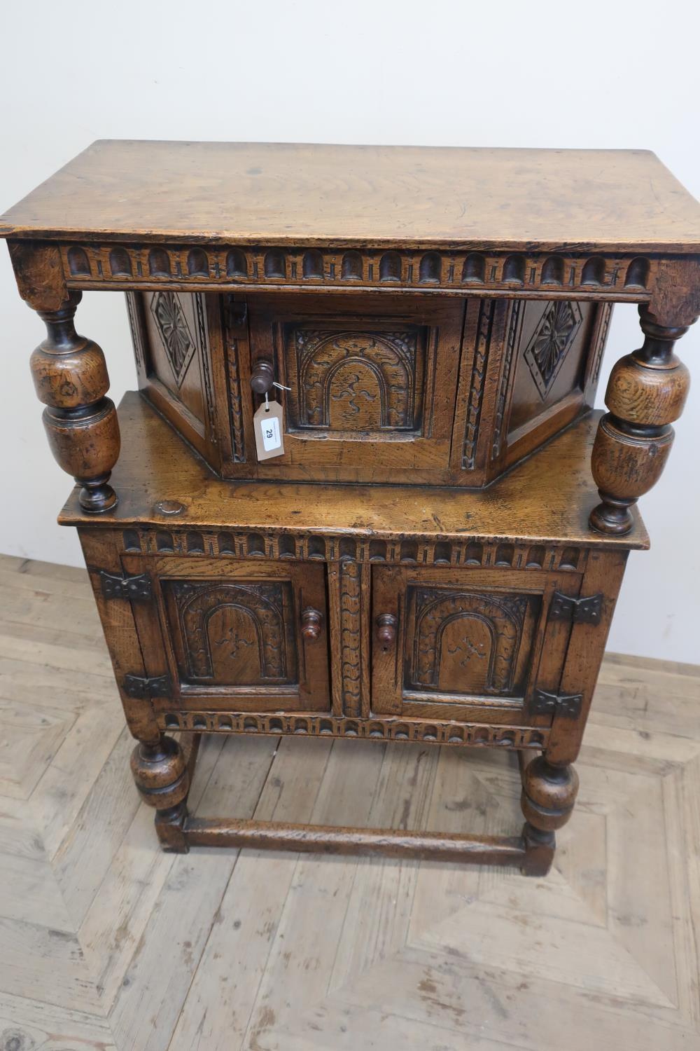 Small 17th C style oak court cupboard, with lunette carved frieze and arch panel door with