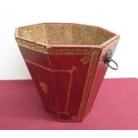 Red and gilt tooled leather wastepaper bin with lion mask handle and central rampant lion detail,