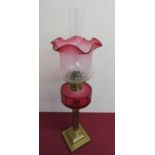 Victorian brass column oil lamp, cranberry glass reservoir and similar shade on stepped square