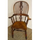 19th C yew and elm broad arm Windsor elbow chair, with pierced shaped splat, out scrolled arms and