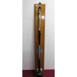 Negretti & Zamra of London brass stick barometer on golden oak wall hanging plaque