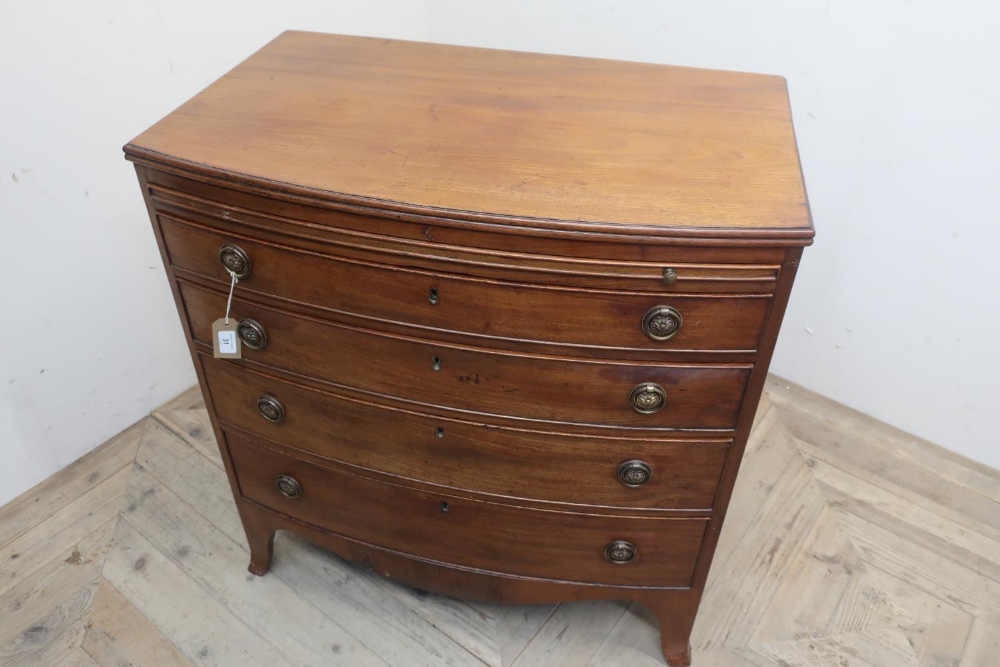 Early 19th C mahogany bow front dressing chest, moulded top above brushing slide and four