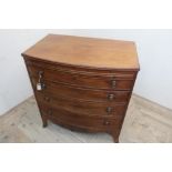 Early 19th C mahogany bow front dressing chest, moulded top above brushing slide and four