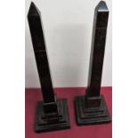 A pair of hard stone obelisks on stamped square bases with engraved Egyptian style hieroglyphics. (