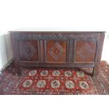 18th century oak coffer, hinged planked top above arched carved frieze and three lozenged panelled