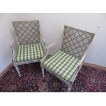 Pair of Sheraton Revival cane seat open arm chairs, the white frames painted with foliage, and