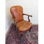 A George I style open armchair with brass nail upholstered leather back and seat, the out-splayed