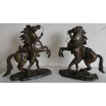 Pair of small bronze models of Marley horsemen, after Cousteau, on naturalistic bases (29cm x 29cm)