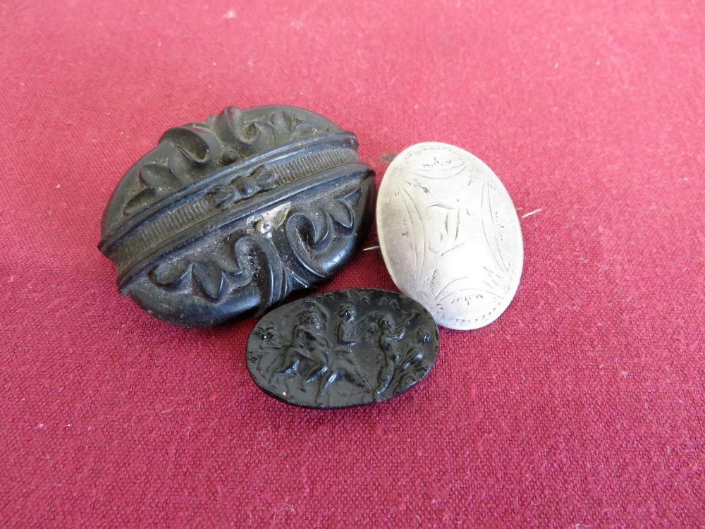 Victorian carved jet brooch, a continental white metal brooch stamped 1896 with rubbed bright cut