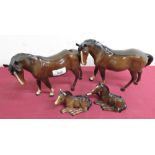 Two Beswick horses with white blazes, and two Beswick foals, both with damage (4)