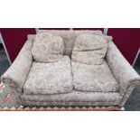 Edwardian two seater sofa, with loose back and seat cushions on bun feet (W150cm x D110cm x H66cm)