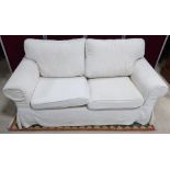 Ikea Ektorp two seat sofa upholstered in loose self patterned cream covers, loose back and seat
