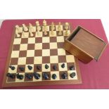 Large turned wooden and ebonized chess set, in mahogany box, on chessboard (king H8.5cm)