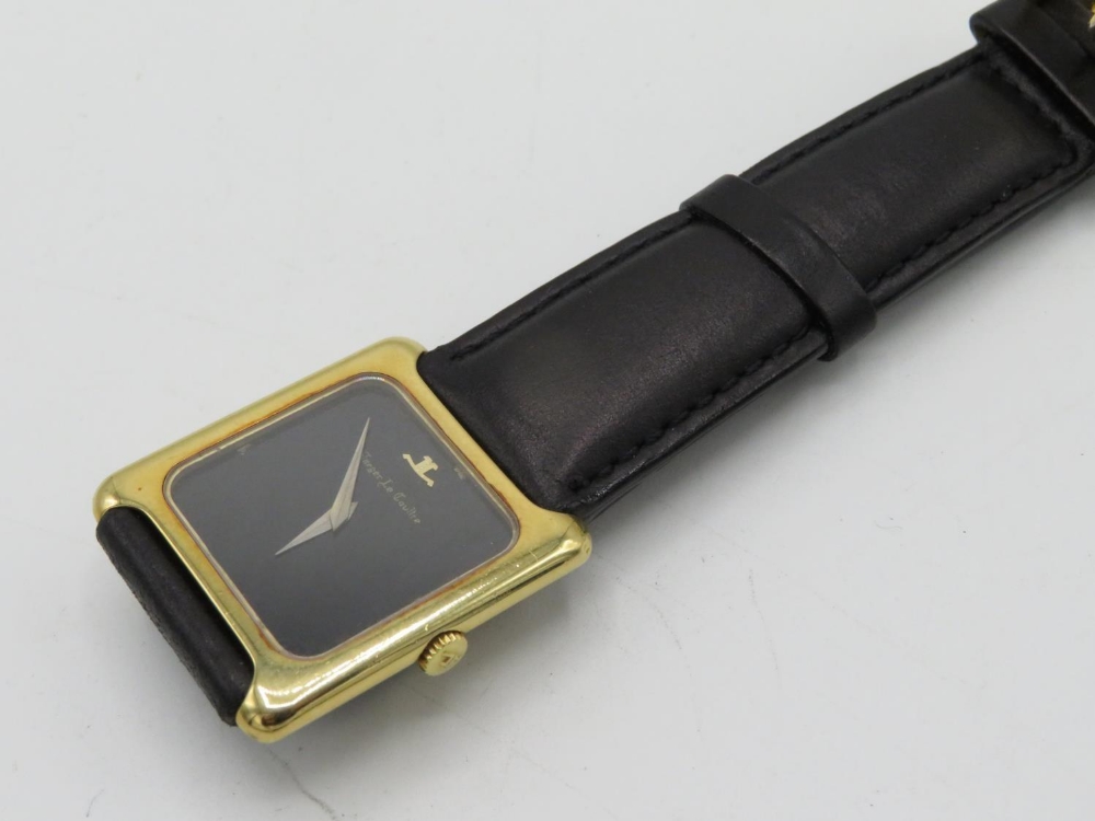 Jaeger Lecoultre hand wound wrist watch. 18K gold case on leather strap, case back stamped 18K, .750